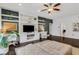 Spacious living room with dark hardwood floors, built-in shelving, a ceiling fan, and abundant natural light at 3467 Brookleigh Ne Ln, Atlanta, GA 30319