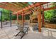 Cozy outdoor fireplace area with stone surround and seating, ideal for entertaining by the pool at 3467 Brookleigh Ne Ln, Atlanta, GA 30319