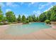 Relaxing pool area surrounded by lounge chairs, umbrellas and lush greenery, perfect for summer days at 3467 Brookleigh Ne Ln, Atlanta, GA 30319