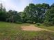 Large backyard featuring lush green grass and mature trees providing shade and privacy at 400 Old Stagecoach Rd, Carrollton, GA 30116