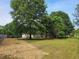 Large, grassy backyard featuring mature trees and plenty of space for outdoor activities at 400 Old Stagecoach Rd, Carrollton, GA 30116