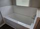 Bathroom featuring a white tiled tub, blinds, and vinyl floor at 400 Old Stagecoach Rd, Carrollton, GA 30116