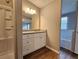 Bathroom featuring a white vanity, mirror, wood-look floors, and walk-in shower at 400 Old Stagecoach Rd, Carrollton, GA 30116