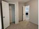 Bedroom with carpet, open closet and view of fireplace in the living room at 400 Old Stagecoach Rd, Carrollton, GA 30116