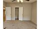 Bedroom featuring neutral carpet and walls, ceiling fan, plus two closets for ample storage space at 400 Old Stagecoach Rd, Carrollton, GA 30116