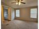 Bedroom features carpet floors, natural lighting and a view of the bathroom through a doorway at 400 Old Stagecoach Rd, Carrollton, GA 30116