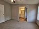 Bedroom featuring neutral walls, a carpet floor, and bathroom access at 400 Old Stagecoach Rd, Carrollton, GA 30116