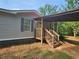 Inviting home with stone accents, covered porch, and stairs leading to the entrance at 400 Old Stagecoach Rd, Carrollton, GA 30116