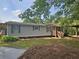 Charming single-story home features a covered porch, landscaped yard, and a convenient carport at 400 Old Stagecoach Rd, Carrollton, GA 30116