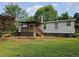 Charming home featuring a covered porch and decorative rock accents along the foundation at 400 Old Stagecoach Rd, Carrollton, GA 30116