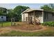Cozy home with a small covered porch with wooden railings and lush green landscaping at 400 Old Stagecoach Rd, Carrollton, GA 30116