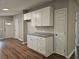 Kitchen boasts white cabinets, granite countertops, and an open view, great for entertaining at 400 Old Stagecoach Rd, Carrollton, GA 30116
