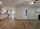 Open-concept living room featuring wood floors, neutral walls, and a fireplace with a pass through to the kitchen at 400 Old Stagecoach Rd, Carrollton, GA 30116