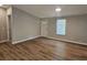 Bright living room features new wood flooring, fresh paint, and natural light at 400 Old Stagecoach Rd, Carrollton, GA 30116