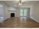Cozy living room boasts a fireplace, access to the deck, and modern ceiling fan at 400 Old Stagecoach Rd, Carrollton, GA 30116