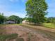 Expansive property featuring a home, a shed and ample parking surrounded by mature trees at 400 Old Stagecoach Rd, Carrollton, GA 30116