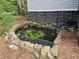 Charming pond with stone edging creating a tranquil outdoor retreat near the home at 400 Old Stagecoach Rd, Carrollton, GA 30116