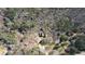 Aerial view showcasing a home's green metal roof nestled in a serene, wooded area with mature trees at 5642 N Highway 212, Covington, GA 30016