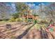 Landscaped backyard with outdoor seating, brick hardscape, and mature trees at 5642 N Highway 212, Covington, GA 30016