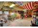 Eclectic basement space with unique decor, showcasing a Coca-Cola machine and ample storage at 5642 N Highway 212, Covington, GA 30016