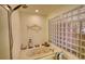Bathroom featuring a jacuzzi tub, fish decorations and glass block window at 5642 N Highway 212, Covington, GA 30016