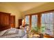 Bedroom featuring natural light, hardwood floors, a large window, and a wooden wardrobe at 5642 N Highway 212, Covington, GA 30016