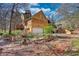 Exterior of a stone house with three-car garage and surrounding natural landscape at 5642 N Highway 212, Covington, GA 30016