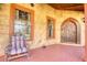 Quaint front porch featuring a rustic chair and decorative accents, offering a delightful and inviting entryway to the home at 5642 N Highway 212, Covington, GA 30016
