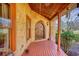 Charming front porch with a wooden floor and an arched front door providing a warm and welcoming ambiance to the residence at 5642 N Highway 212, Covington, GA 30016