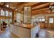 Open kitchen with an island range, wood countertops, wood cabinets, and adjacent Gathering room at 5642 N Highway 212, Covington, GA 30016