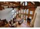 Spacious living room featuring a fireplace, hardwood floors, and high ceilings with exposed wooden beams at 5642 N Highway 212, Covington, GA 30016