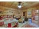 Comfortable main bedroom with wood-paneled walls, a plush chaise lounge, and a view into the bathroom at 5642 N Highway 212, Covington, GA 30016