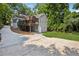 Exterior view of home with a patio, deck and a large driveway leading around the back of the house at 22 Peachtree Hills Ne Ave, Atlanta, GA 30305