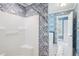 Bathroom features white shower, blue wallpaper, and a door leading to a separate area with a soaking tub at 22 Peachtree Hills Ne Ave, Atlanta, GA 30305