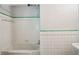 Classic bathroom featuring white tiles, a tub, and a shower combo with a white wall at 22 Peachtree Hills Ne Ave, Atlanta, GA 30305
