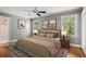 Serene bedroom with gray walls, hardwood floors, ceiling fan, and natural light from windows at 22 Peachtree Hills Ne Ave, Atlanta, GA 30305