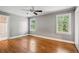 Bright and airy bedroom with hardwood floors, neutral gray walls and two bright windows at 22 Peachtree Hills Ne Ave, Atlanta, GA 30305