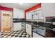 Kitchen with stainless steel appliances, black and white checkered floors, and a window into an adjacent room at 22 Peachtree Hills Ne Ave, Atlanta, GA 30305