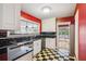 Stylish kitchen with black and white checkered floors, stainless steel appliances, and bright red walls at 22 Peachtree Hills Ne Ave, Atlanta, GA 30305