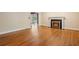 Spacious living room with hardwood floors, a fireplace, and a view into another room through an open doorway at 22 Peachtree Hills Ne Ave, Atlanta, GA 30305
