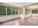 Sunroom showcasing hardwood floors and an abundance of natural light from the numerous windows at 22 Peachtree Hills Ne Ave, Atlanta, GA 30305