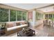 Bright sunroom with large windows, a comfortable couch and a dining area filled with light at 22 Peachtree Hills Ne Ave, Atlanta, GA 30305