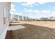 Expansive backyard featuring a patio, newly seeded lawn and a partial view of nearby residences at 2625 Mourning Dove Dr (Lot 47), Grayson, GA 30017