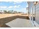 View of the backyard with a concrete patio, a newly seeded lawn, and view of neighboring homes at 2625 Mourning Dove Dr (Lot 47), Grayson, GA 30017