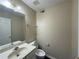 Neutral-toned half bathroom featuring a vanity, mirror, and toilet at 312 Yarbrough Ct, Dacula, GA 30019