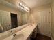 Bright bathroom with double sinks and a large mirror at 312 Yarbrough Ct, Dacula, GA 30019
