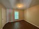 Bright bedroom with a window providing natural light and sleek wood-look flooring at 312 Yarbrough Ct, Dacula, GA 30019