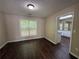 Dining room with wood flooring, window with blinds and view to the kitchen at 312 Yarbrough Ct, Dacula, GA 30019