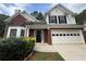 Charming two-story home with brick accents, a two-car garage, and a manicured front yard at 312 Yarbrough Ct, Dacula, GA 30019