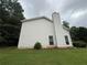 Back exterior of a two-story home with a chimney and green lawn at 312 Yarbrough Ct, Dacula, GA 30019